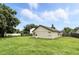 Expansive backyard featuring lush lawn and neutral exterior of home, surrounded by a wood fence for privacy at 7810 Wortham Ct, Orlando, FL 32825