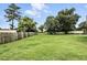 Lush backyard space featuring a well-kept lawn area bordered by wooden privacy fence at 7810 Wortham Ct, Orlando, FL 32825