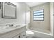 Bathroom features a single vanity, toilet, and a shower-tub combo with a window at 7810 Wortham Ct, Orlando, FL 32825