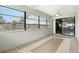 A bright and airy Florida room with neutral tile floor and many windows at 7810 Wortham Ct, Orlando, FL 32825