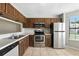 Traditional kitchen with stainless steel appliances and wood cabinets at 7810 Wortham Ct, Orlando, FL 32825