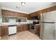 Traditional kitchen with stainless steel appliances and wood cabinets at 7810 Wortham Ct, Orlando, FL 32825