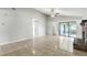 Large living room with neutral walls, tile flooring, recessed lighting, and access to the screened-in patio at 7810 Wortham Ct, Orlando, FL 32825