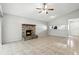 Well-lit living room featuring tile floors, a brick fireplace, a pass-through to the kitchen, and access to the front entry at 7810 Wortham Ct, Orlando, FL 32825