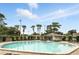 Community pool with lounge chairs, surrounded by well-manicured landscaping, providing a relaxing atmosphere at 7810 Wortham Ct, Orlando, FL 32825