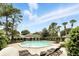 Community pool with lounge chairs, surrounded by lush landscaping, offering a resort-style amenity at 7810 Wortham Ct, Orlando, FL 32825