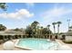 Relaxing community pool featuring a sun deck with plenty of lounge chairs, surrounded by trees and landscaping at 7810 Wortham Ct, Orlando, FL 32825