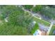 Overhead perspective showcasing a home with a green lawn, mature trees, and swimming pool in its private backyard at 805 E 20Th St, Sanford, FL 32771