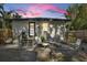 Cozy backyard patio with lounge chairs and lush landscaping under a colorful dusk sky at 805 E 20Th St, Sanford, FL 32771