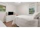 Bright bedroom with wood floors and an abundance of natural light, featuring a comfy bed and white furniture at 805 E 20Th St, Sanford, FL 32771