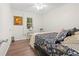 Cozy bedroom featuring wood floors, bright natural light, and a decorative painting on the wall at 805 E 20Th St, Sanford, FL 32771