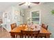 Charming dining area with floral wallpaper, wooden furniture, and a bright window at 805 E 20Th St, Sanford, FL 32771