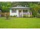 Charming home featuring a quaint porch, well-maintained lawn, and patriotic decorations at 805 E 20Th St, Sanford, FL 32771