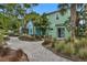 Landscaped backyard featuring stone paths, tropical trees, and comfortable seating areas with backyard access at 8061 Lost Shaker Ln, Kissimmee, FL 34747