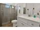 Modern bathroom featuring a glass-enclosed shower, white vanity with quartz countertop, and wood-look flooring at 8061 Lost Shaker Ln, Kissimmee, FL 34747