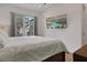 Cozy bedroom with a plush bed, balcony access, and a large flat-screen TV showing community swimming pool at 8061 Lost Shaker Ln, Kissimmee, FL 34747