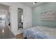 Comfortable bedroom featuring a full-length mirror, stylish artwork, and a queen bed with soft bedding at 8061 Lost Shaker Ln, Kissimmee, FL 34747
