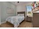 Relaxing bedroom with queen bed, modern furnishings, beachy colors, and beach artwork on the wall at 8061 Lost Shaker Ln, Kissimmee, FL 34747
