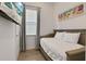Small, yet functional bedroom with a trundle bed and beach themed art on the wall at 8061 Lost Shaker Ln, Kissimmee, FL 34747