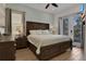 Comfortable bedroom featuring a large bed, a side table with lamps, and large windows for natural light at 8061 Lost Shaker Ln, Kissimmee, FL 34747
