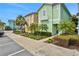 Exterior view of colorful homes with manicured landscaping and a well-maintained sidewalk for curb appeal at 8061 Lost Shaker Ln, Kissimmee, FL 34747