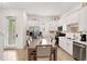 Spacious kitchen features stainless steel appliances, white cabinetry, and a dining area with ample seating at 8061 Lost Shaker Ln, Kissimmee, FL 34747