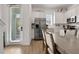 Bright kitchen and dining area with stainless steel appliances, white cabinetry, and a modern dining table at 8061 Lost Shaker Ln, Kissimmee, FL 34747
