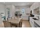 Modern kitchen with stainless steel appliances, quartz countertops, and an adjacent dining area at 8061 Lost Shaker Ln, Kissimmee, FL 34747