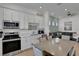 Modern kitchen with white cabinets, stainless steel appliances, quartz countertops, and an adjacent dining area at 8061 Lost Shaker Ln, Kissimmee, FL 34747