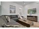 Comfortable living room with a plush gray sectional sofa, decorative artwork, and a flat-screen television at 8061 Lost Shaker Ln, Kissimmee, FL 34747