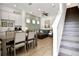 Open-concept living room with kitchen, dining table, comfortable seating and staircase to the second floor at 8061 Lost Shaker Ln, Kissimmee, FL 34747