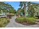 Charming street view of colorful townhouses surrounded by lush landscaping and paved walkways, offering a vibrant community setting at 8061 Lost Shaker Ln, Kissimmee, FL 34747