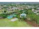 Aerial view of community amenities featuring a tennis court, volleyball court, and swimming pool at 12524 Aldershot Ln, Windermere, FL 34786