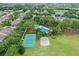 Aerial view of the community tennis court, sand volleyball court, and swimming pool at 12524 Aldershot Ln, Windermere, FL 34786