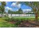 An outdoor basketball court surrounded by a fence and green landscaping at 12524 Aldershot Ln, Windermere, FL 34786