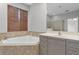 Bathroom featuring a soaking tub with decorative tile and gray vanities at 12524 Aldershot Ln, Windermere, FL 34786