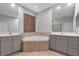 A well-lit bathroom with dual vanities, a soaking tub, and decorative tile at 12524 Aldershot Ln, Windermere, FL 34786