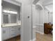 Bathroom with a double sink vanity, gray walls, white trim and drawers, with wood floors visible at 12524 Aldershot Ln, Windermere, FL 34786