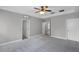 Spacious bedroom with tray ceilings, neutral paint and carpet, and a ceiling fan at 12524 Aldershot Ln, Windermere, FL 34786