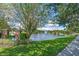 Landscaped 'Lakes of Windermere' entrance sign next to a picturesque lake with a fountain at 12524 Aldershot Ln, Windermere, FL 34786