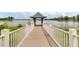 A beautiful dock on a lake with a covered gazebo at 12524 Aldershot Ln, Windermere, FL 34786