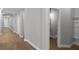 Hallway featuring wood floors leading to a bathroom and other rooms at 12524 Aldershot Ln, Windermere, FL 34786