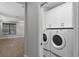Well-equipped laundry room with modern washer and dryer and ample storage cabinets at 12524 Aldershot Ln, Windermere, FL 34786