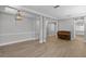 Open-concept living room features hardwood floors and an elegant light fixture at 12524 Aldershot Ln, Windermere, FL 34786