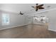 Open living room features wood floors, plantation shutters, and modern ceiling fans at 12524 Aldershot Ln, Windermere, FL 34786