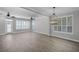 Bright living room with wood floors, plantation shutters, and modern ceiling fans at 12524 Aldershot Ln, Windermere, FL 34786
