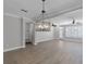 Open-concept living room boasts modern lighting, wood flooring, and neutral paint tones at 12524 Aldershot Ln, Windermere, FL 34786