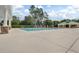 Large community pool with ample seating and a covered lounge area at 12524 Aldershot Ln, Windermere, FL 34786