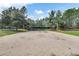 A sand volleyball court with trees in the background at 12524 Aldershot Ln, Windermere, FL 34786