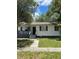 Charming single-story home with a covered porch and well-maintained front yard, creating inviting curb appeal at 2075 Dixie Ave, Sanford, FL 32771